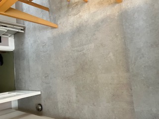 Large format stone-effect vinyl flooring laid through a hallway