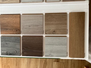 Wood-effect flooring samples in grey, natural and smoked finishes